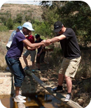 Helping each other to cross bridges.